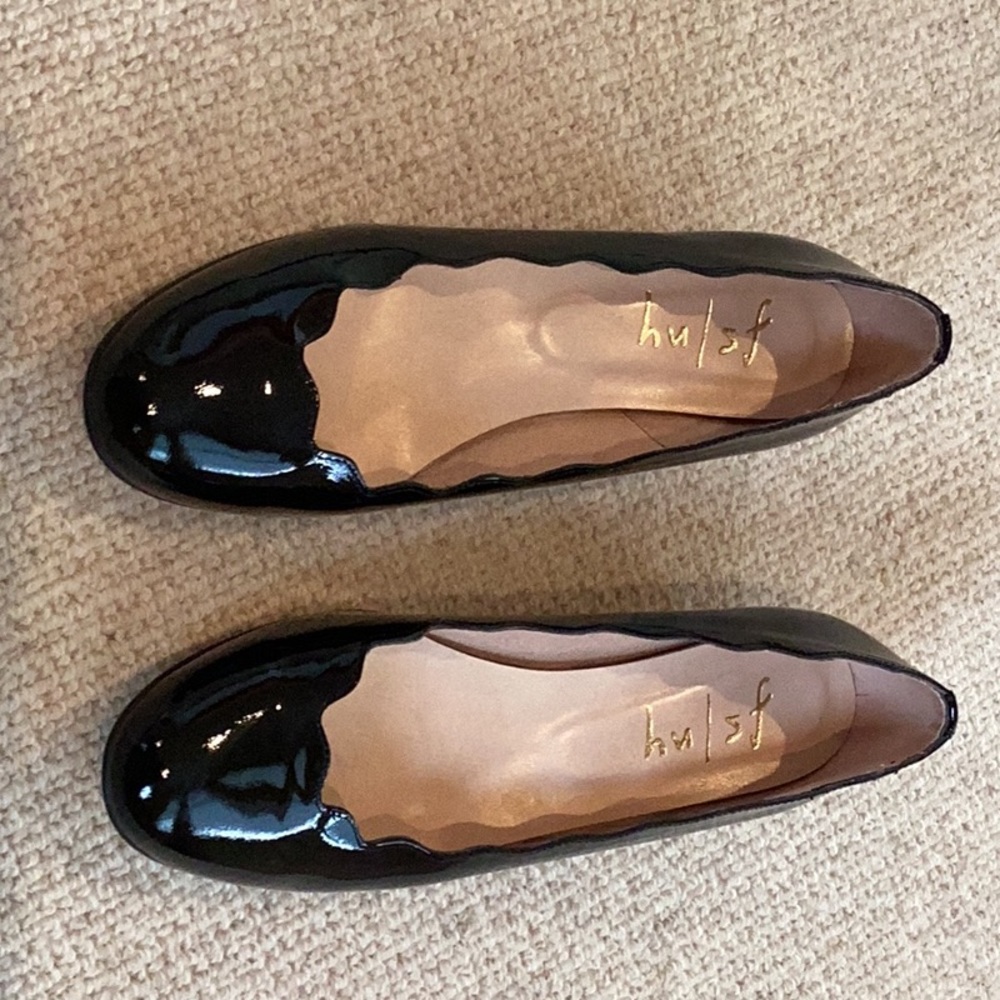 Black patent luxury brand shoes.